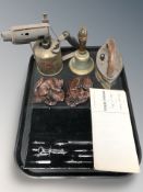 A brass blow torch, an iron bell, precision drawing set, two carvings.