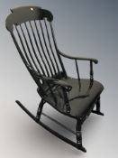 An ebonised rocking chair
