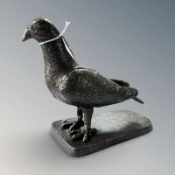 A bronzed metal figure of a pigeon on plinth, height 18 cm.
