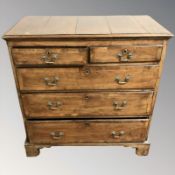 A George III provincial walnut and pine five drawer chest,