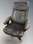 A Scandinavian swivel black leather armchair,