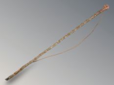 A Victorian twist glass cane containing beads, length 72 cm.