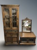 A reproduction carved oak leaded glass corner cabinet, similar double door low cabinet and mirror.