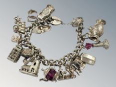 A heavy white metal charm bracelet with silver clasp CONDITION REPORT: 108.
