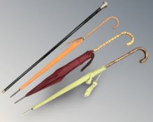 An ebonised walking cane with silver pommel, two Fox & Co Paragon parasols, and a further parasol.