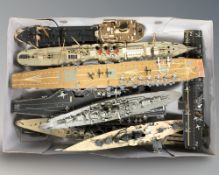A quantity of scale model battleships and an aircraft carrier.