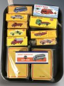 A group of Atlas Editions Dinky cars and delivery vans, in boxes.