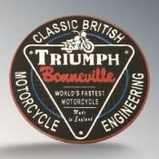 A cast iron Triumph plaque, diameter 25 cm.