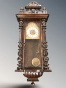 A mahogany Vienna style eight day wall clock with pendulum and key, height 117 cm.