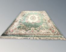 A large Chinese floral woolen carpet on green ground, 480 cm x 365 cm.