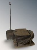 A set of foot bellows and a wrought iron shovel.