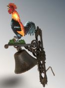 A cast iron cockerel wall bell on bracket, height 45 cm.