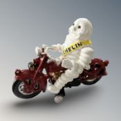 A cast iron Michelin man on motorbike figure, height 16 cm.
