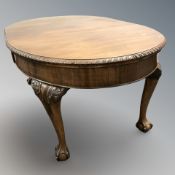 An early 20th century carved mahogany extending dining table, with leaf,