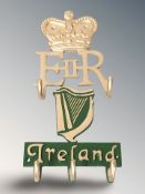Two cast metal coat racks, EIIR and Ireland, width 18 cm.
