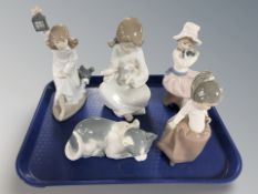 Four Nao figures of children and a further figure of a cat.