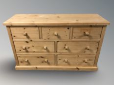 A modern pine seven drawer chest,