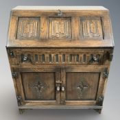 An oak linen fold bureau, 76 cm x 42 cm x 92 cm.