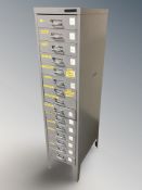 An enameled metal fifteen drawer index chest, 28 cm W x 42 cm D x 120 cm H.