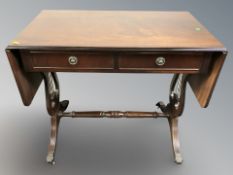 A reproduction mahogany drop leaf sofa table,