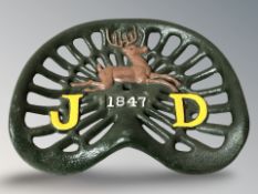 A cast iron tractor seat, width 43 cm.