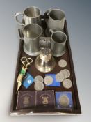 A mahogany twin handled drinks tray containing pewter tankards, bell, candle snuffer,