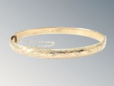 A 9ct yellow gold bangle, 64 mm x 55 mm CONDITION REPORT: 16.