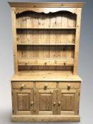 A reproduction pine dresser, 122 cm x 47 cm x 206 cm.