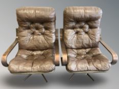A pair of 20th century Scandinavian bent wood and brown button leather armchairs,
