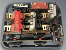 A group of tin plate rolling stock including locomotive, passenger cars, etc.