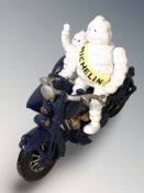 A cast iron Michelin man on motorbike with sidecar figure, length 23 cm.