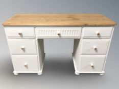 A painted oak dressing table fitted with seven drawers,
