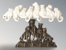 Two cast iron cat and dog key racks, largest 34 cm wide.