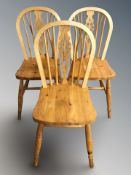 Three pine spindle back dining chairs and a further 19th century child's ebonised chair.