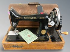 A Singer hand sewing machine in oak case