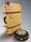 A vintage leather luggage case and a tapestry circular footstool
