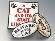 Three cast iron oval plaques including 'Beware of the cat', largest 19.5 cm wide.