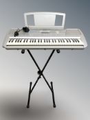 A Yamaha PSR-290 digital keyboard, with lead and folding stand.