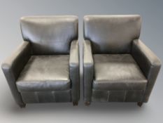 A pair of stitched black leather armchairs,