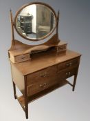 An Edwardian mahogany and satinwood banded three drawer mirror backed dressing table,