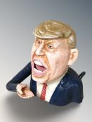 A cast iron Donald Trump money bank, height 17 cm.