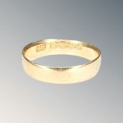 An 18ct gold band ring, size M CONDITION REPORT: 2.