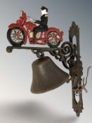 A cast iron man on motorcycle wall bell on bracket, height 34 cm.