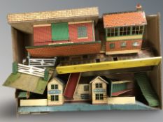 A group of tin plate model railway buildings and accessories.