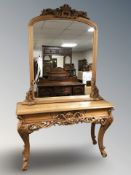 A reproduction carved pine console table and matching mirror above,