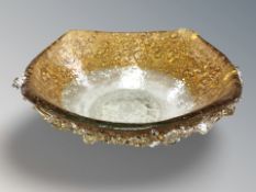 A textured two tone amber glass bowl, width 22 cm.