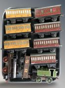 A group of tin plate rolling stock including locomotive, passenger cars, etc.