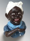 A cast iron money bank in the form of a lady, height 17 cm.