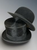 A gent's French black silk top hat and a further black felt bowler hat by Guesdon, Paris.