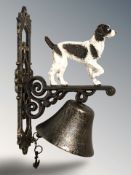 A cast iron spaniel wall bell on bracket, height 34 cm.